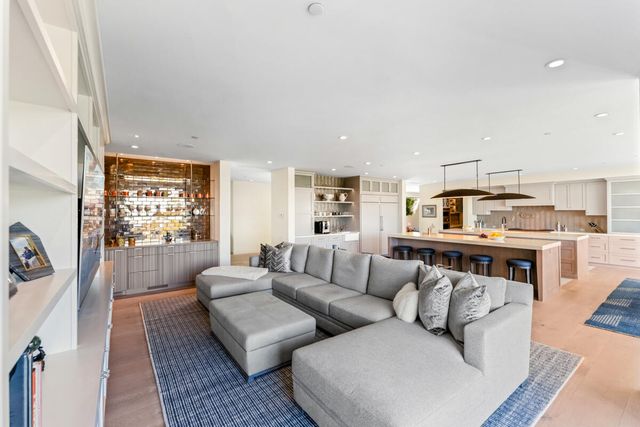 a living room with furniture and kitchen view