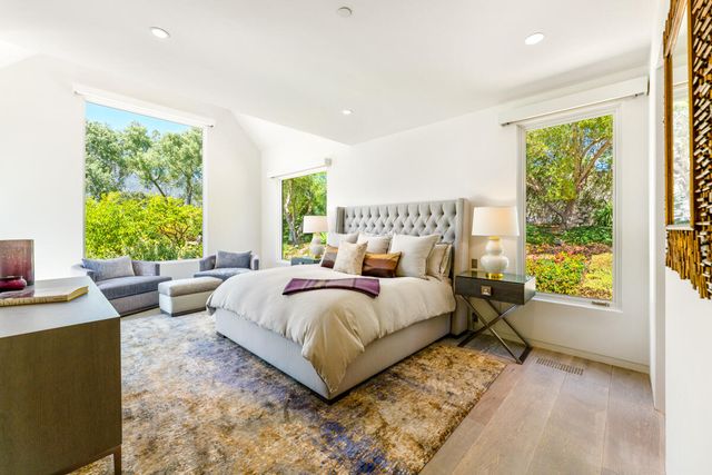 a bedroom with a bed and a large window