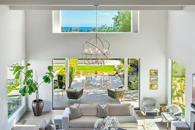 a large white kitchen with a large window