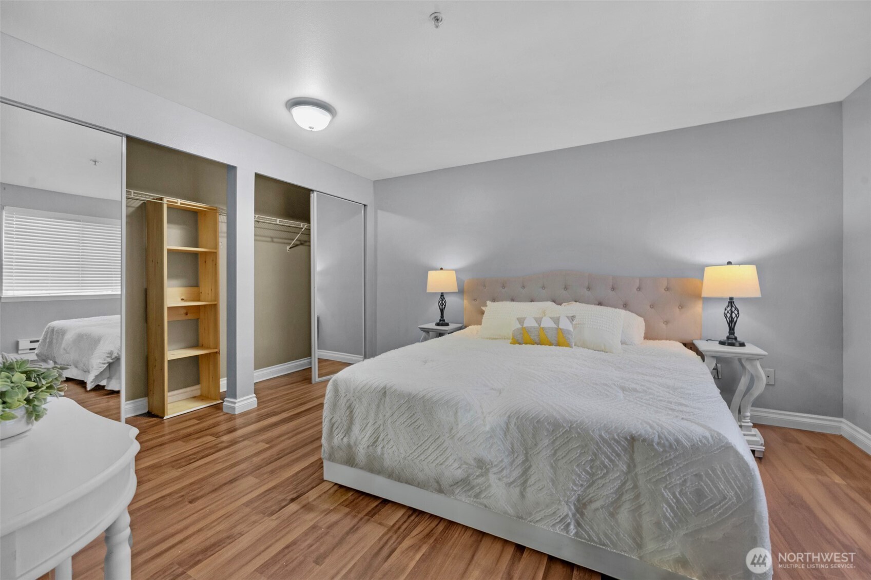 1001 West Casino Road, Unit B101 Everett, WA 98204 - Photo 11 of 19 a bedroom with a bed and wooden floor