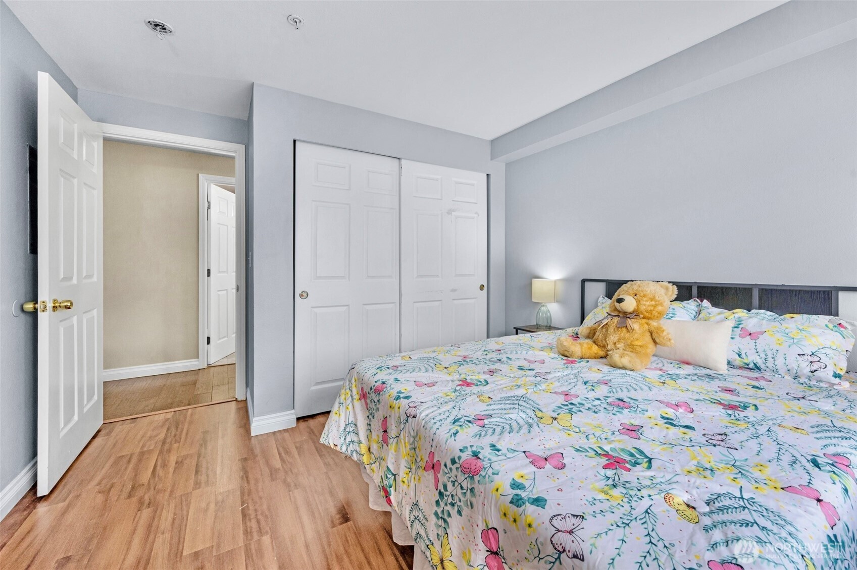 1001 West Casino Road, Unit B101 Everett, WA 98204 - Photo 14 of 19 a bedroom with a bed and wooden floor