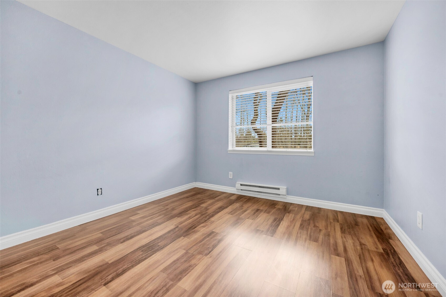 1001 West Casino Road, Unit B101 Everett, WA 98204 - Photo 17 of 19 an empty room with wooden floor and windows