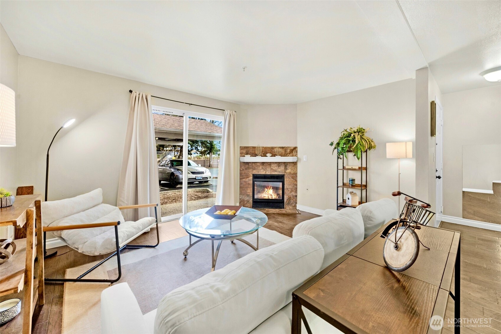 1001 West Casino Road, Unit B101 Everett, WA 98204 - Photo 4 of 19 a living room with furniture a fireplace and a large window