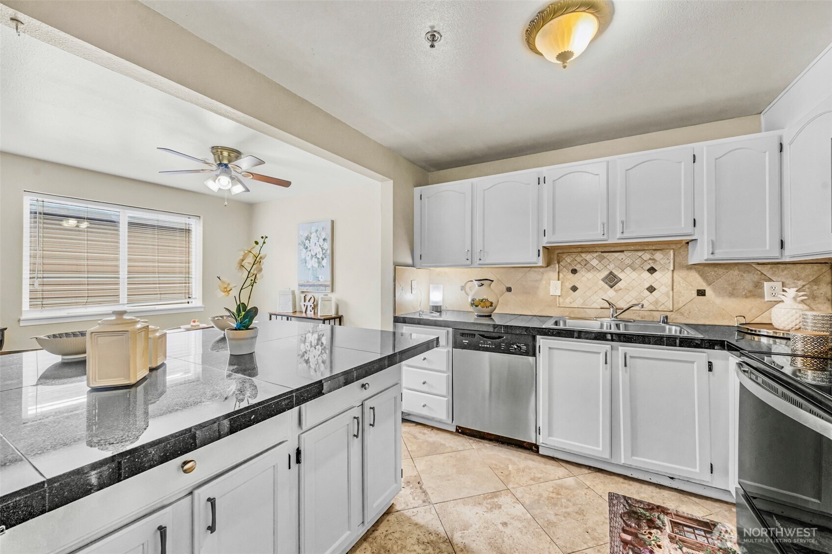 1001 West Casino Road, Unit B101 Everett, WA 98204 - Photo 7 of 19 a kitchen with granite countertop a sink stainless steel appliances and cabinets