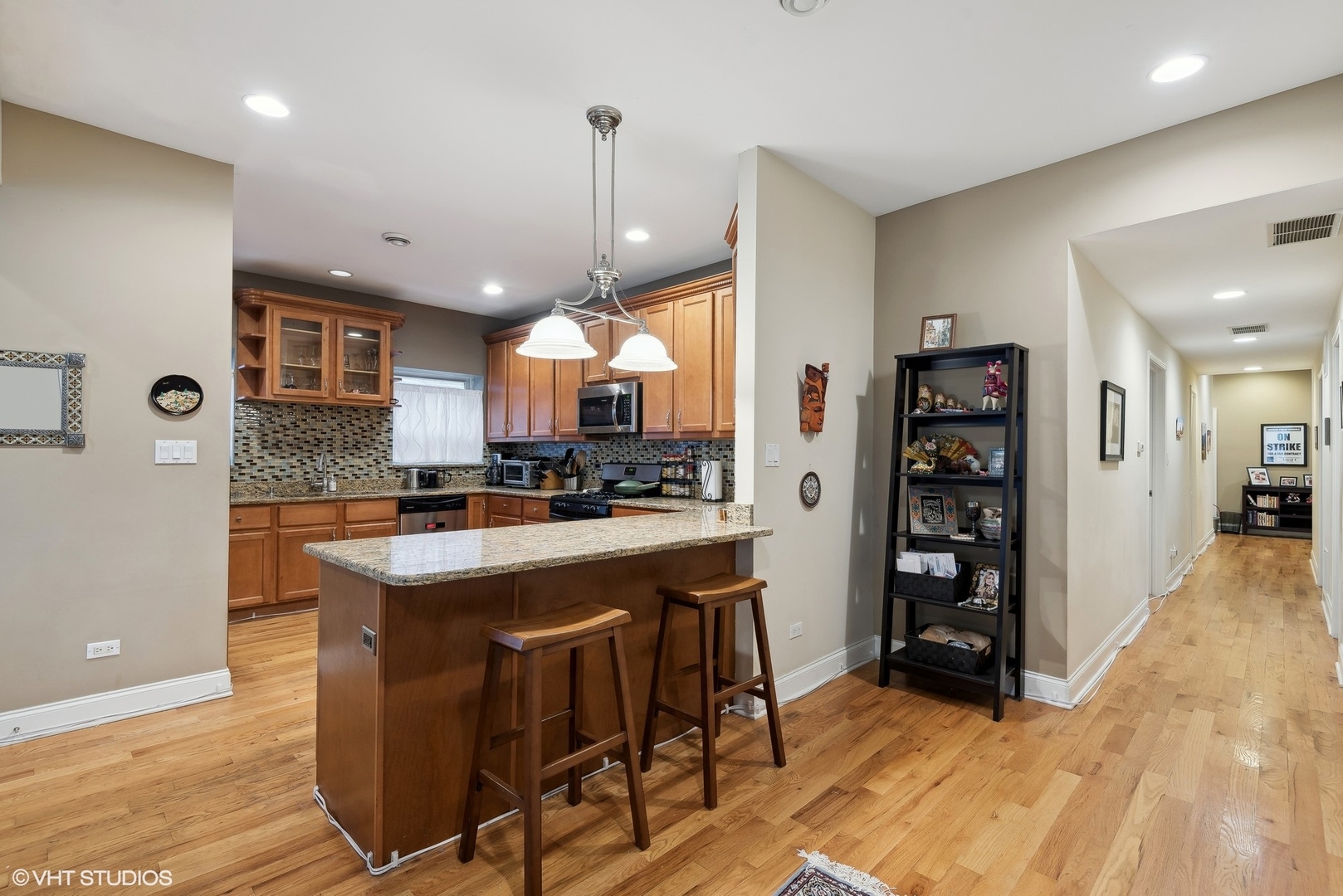 1116 East 46th Street, Unit 3W Chicago, IL 60653 - Photo 5 of 16 a kitchen with stainless steel appliances granite countertop a refrigerator a stove and a wooden floors