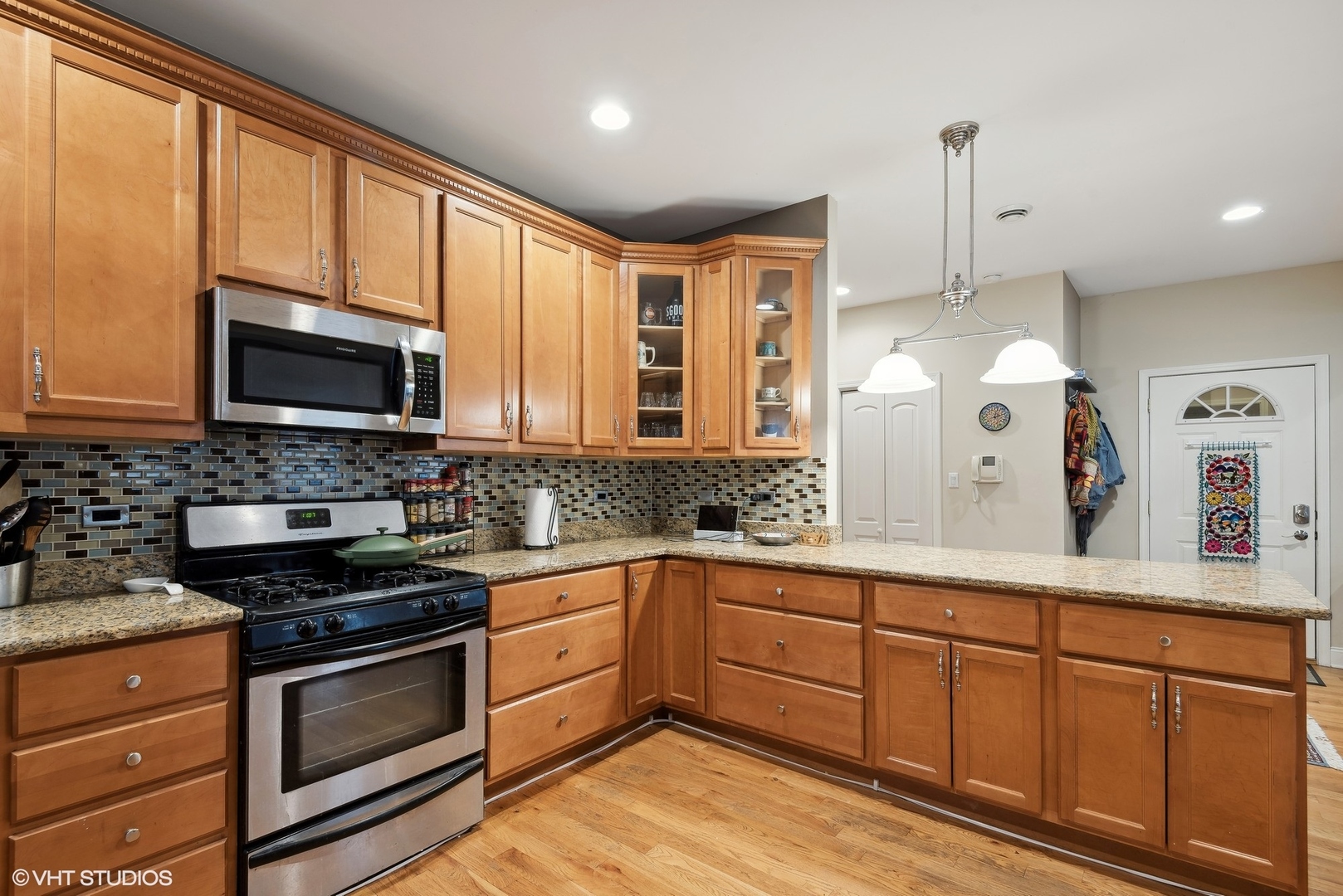 1116 East 46th Street, Unit 3W Chicago, IL 60653 - Photo 7 of 16 a kitchen with stainless steel appliances granite countertop a stove a sink and a microwave