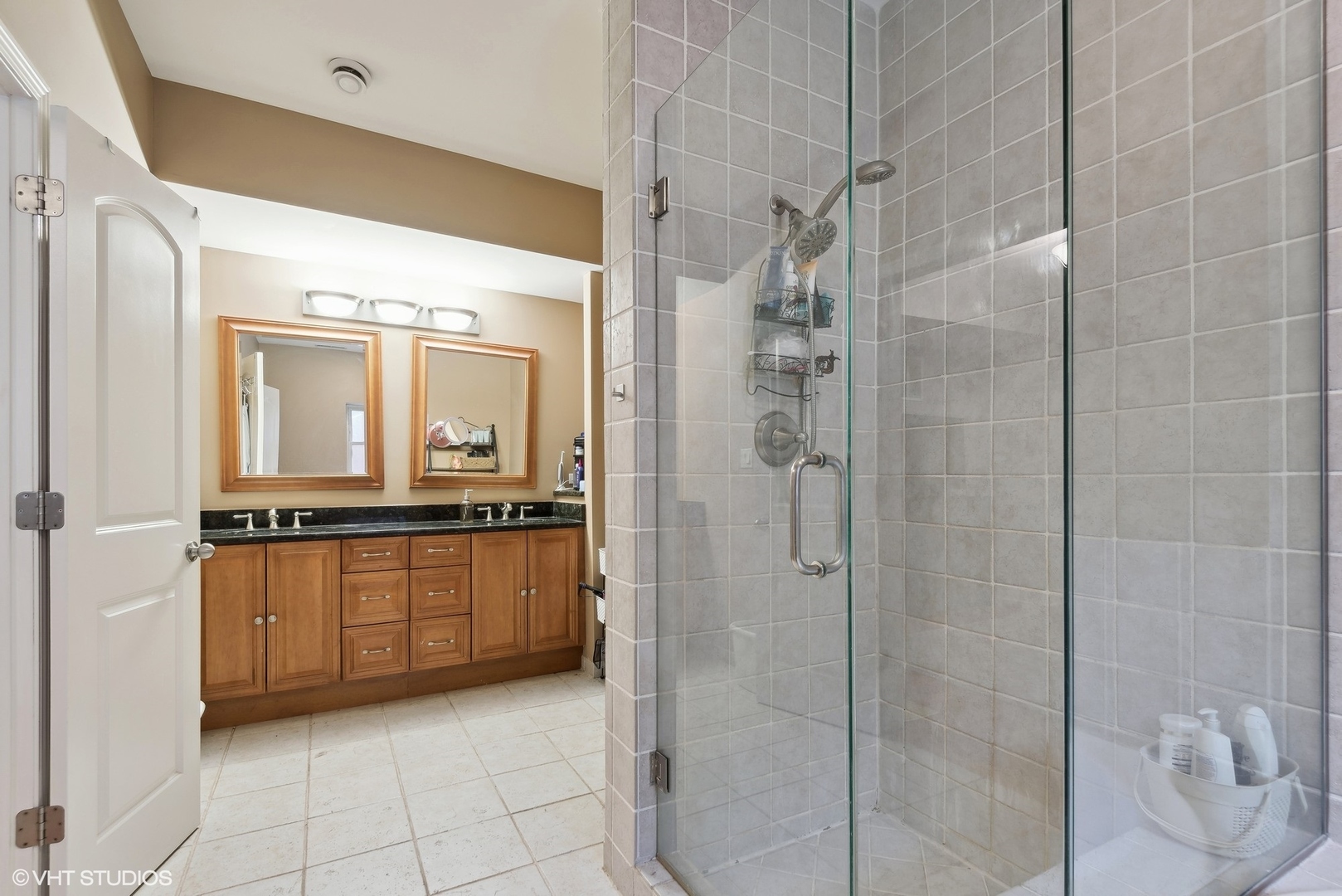 1116 East 46th Street, Unit 3W Chicago, IL 60653 - Photo 10 of 16 a bathroom with a granite countertop sink a mirror and a shower
