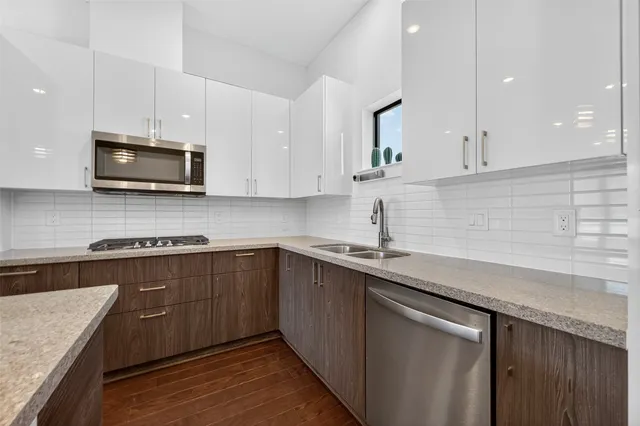 a stove top oven sitting inside of a kitchen