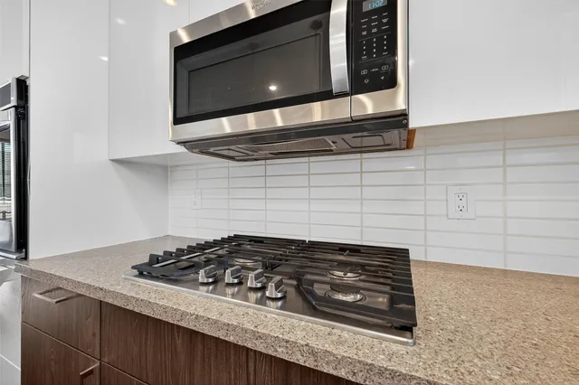 a hallway with stairs and wooden floor