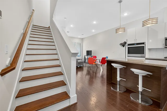 a view of a hallway with wooden floor and entryway