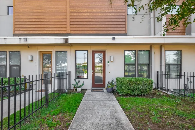 a view of a house with a garden and pathway