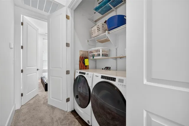 a large bed sitting in a bedroom and chandelier