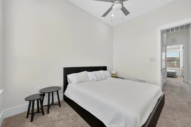 a bedroom with a bed a table and chair