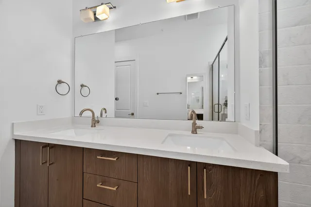 a bathroom with a shower and a sink