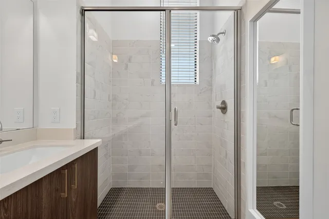 a bathroom with a double vanity sink and mirror