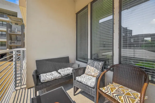 a balcony with furniture and a potted plant