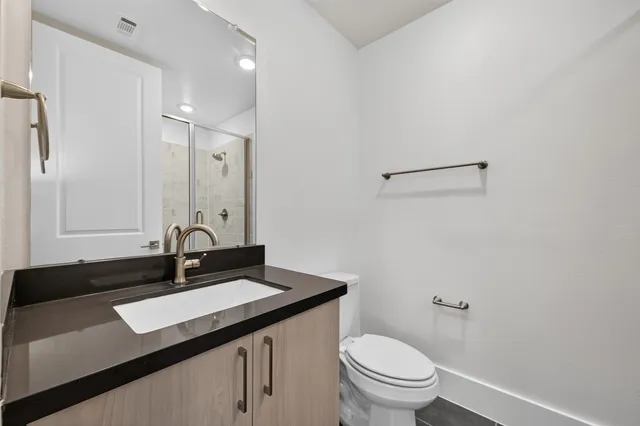 a bathroom with a glass shower door