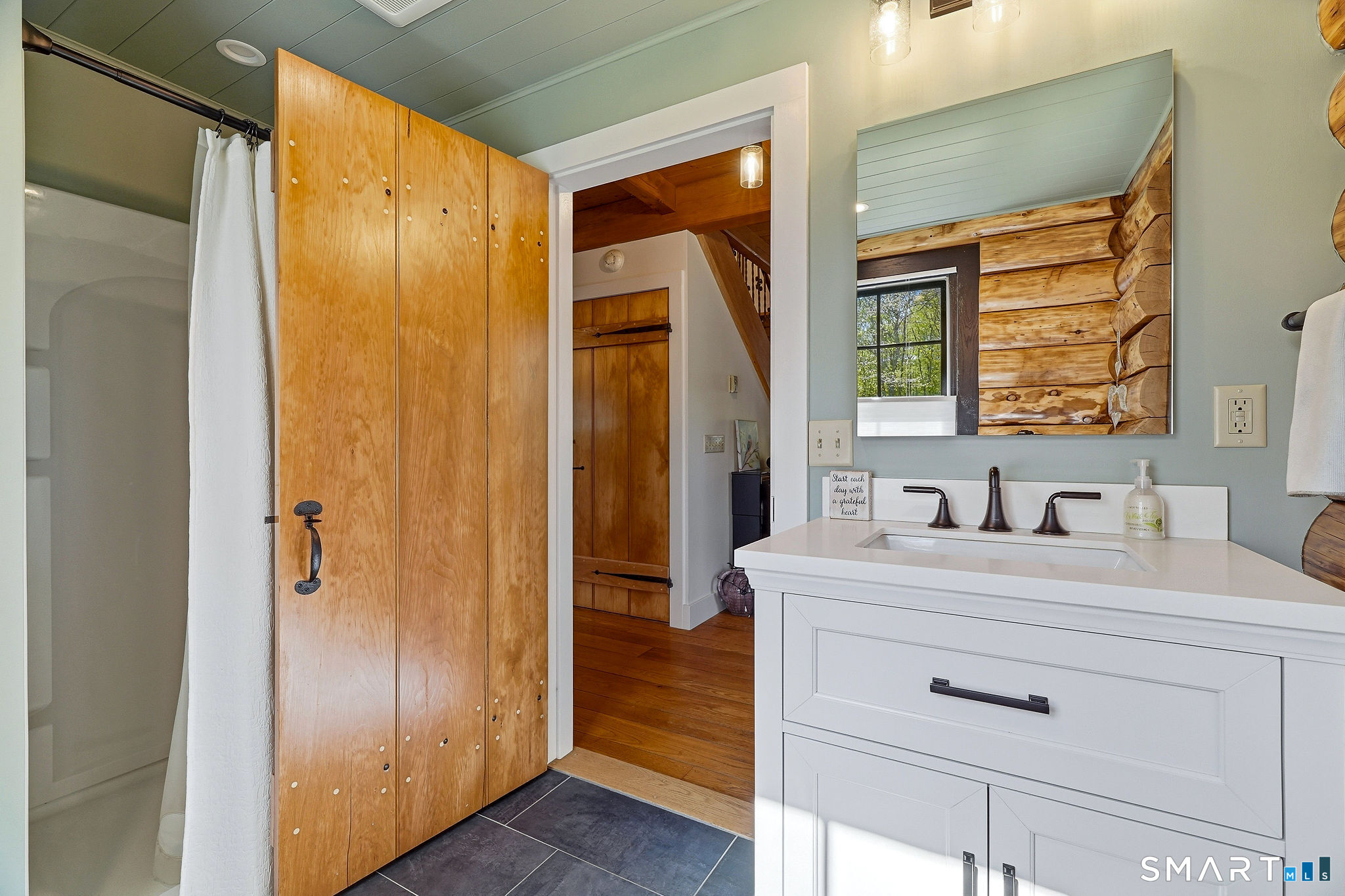 61 Mystic Road North Stonington, CT 06359 - Photo 24 of 40 a bathroom with a shower sink and mirror