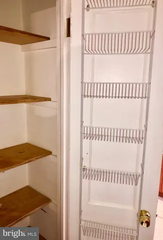 an empty room with wooden floor and window