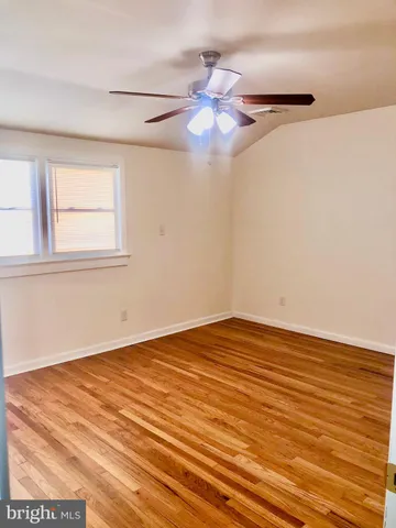 a view of a terrace with wooden floor and a window