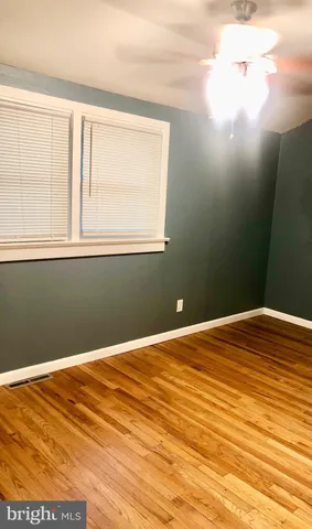 an empty room with wooden floor and closet