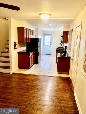 a kitchen with stainless steel appliances granite countertop a refrigerator and cabinets