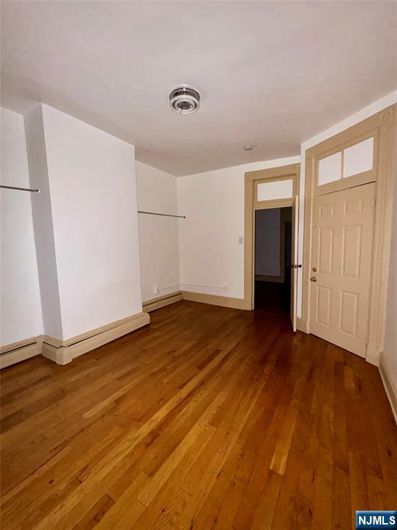108 32nd Street Union City, NJ 07087 - Photo 9 of 10 a view of an empty room with wooden floor and a window