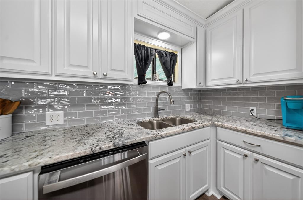 23363 Wateridge Loop Flint, TX 75762 - Photo 24 of 40 a kitchen with granite countertop a sink stainless steel appliances white cabinets and a window