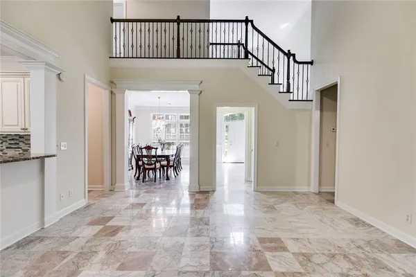 a kitchen with stainless steel appliances granite countertop a sink refrigerator and cabinets