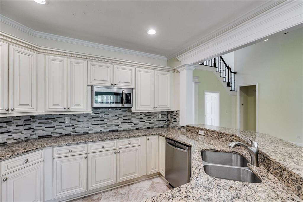 110 Pond View Point LaGrange, GA 30240 - Photo 14 of 65 a kitchen with granite countertop a sink stove and cabinets