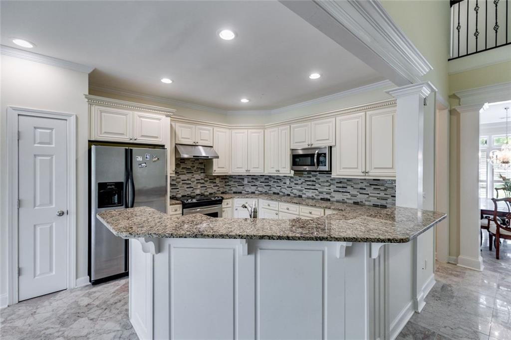 110 Pond View Point LaGrange, GA 30240 - Photo 15 of 65 a kitchen with stainless steel appliances granite countertop a sink refrigerator and cabinets