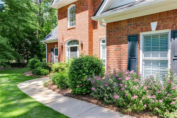 a front view of a house with a garden