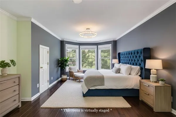 a front view of a house with a yard and trees