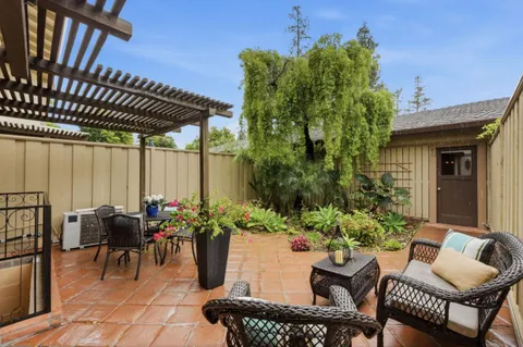a backyard of a house with outdoor seating