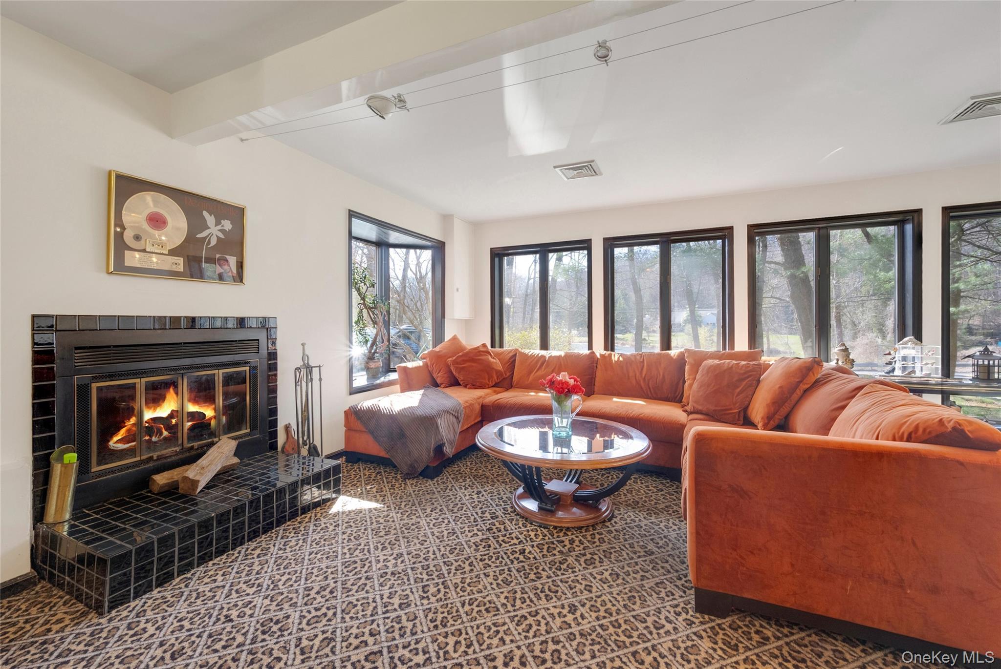 119 Goldens Bridge Road Katonah, NY 10536 - Photo 17 of 34 a living room with furniture a fireplace and a floor to ceiling window