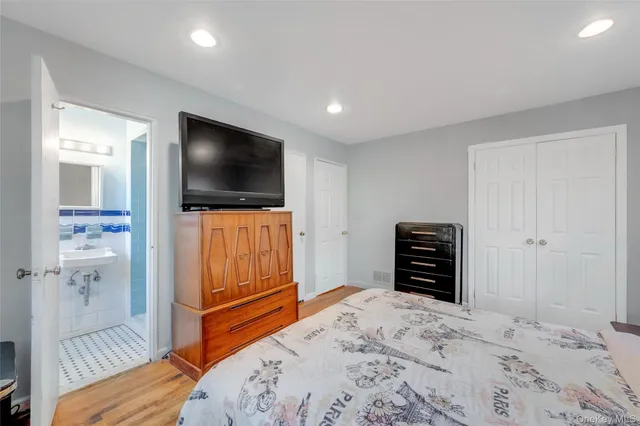 a bedroom with furniture and flat screen tv