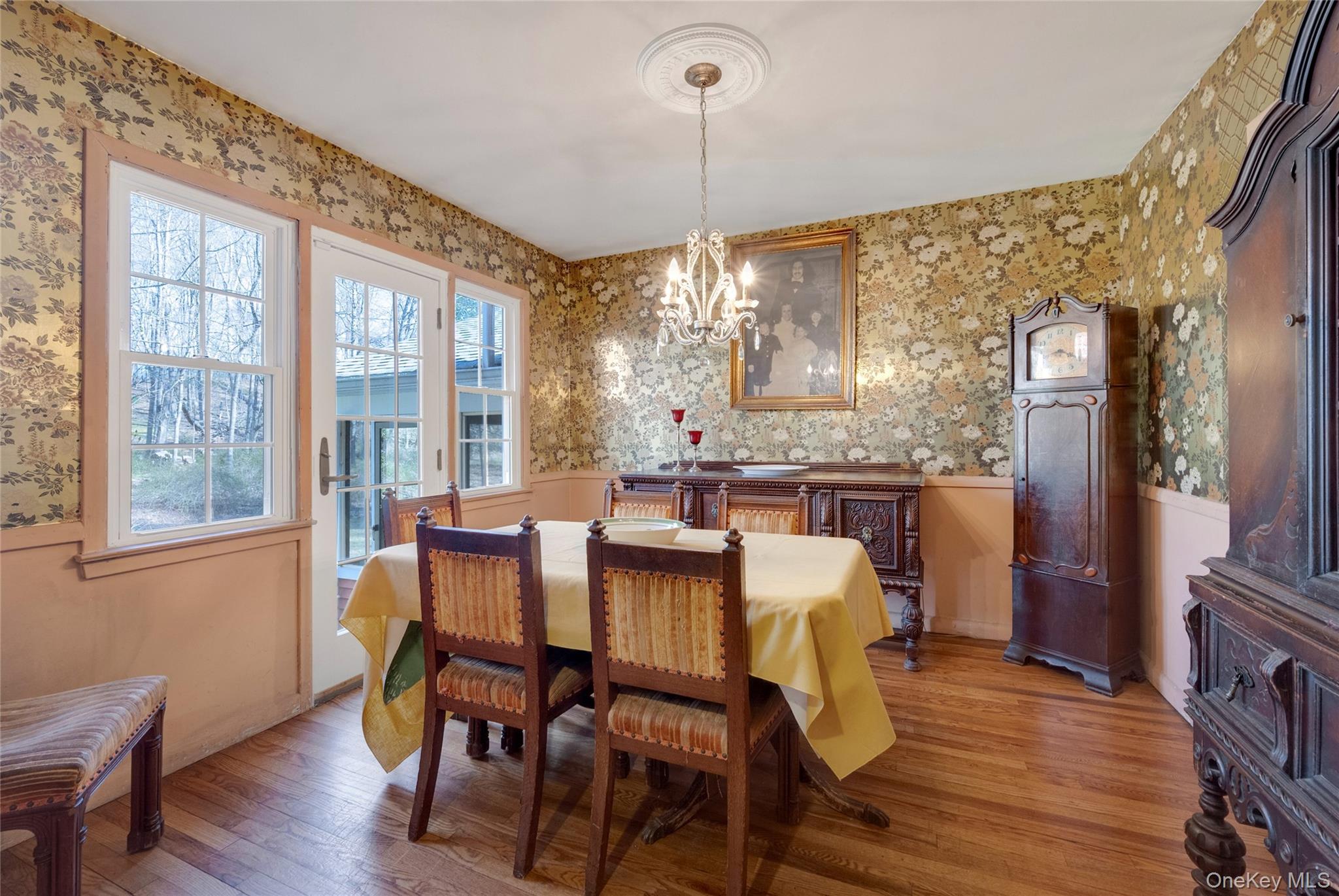 119 Goldens Bridge Road Katonah, NY 10536 - Photo 9 of 34 a dining room with furniture a chandelier and wooden floor