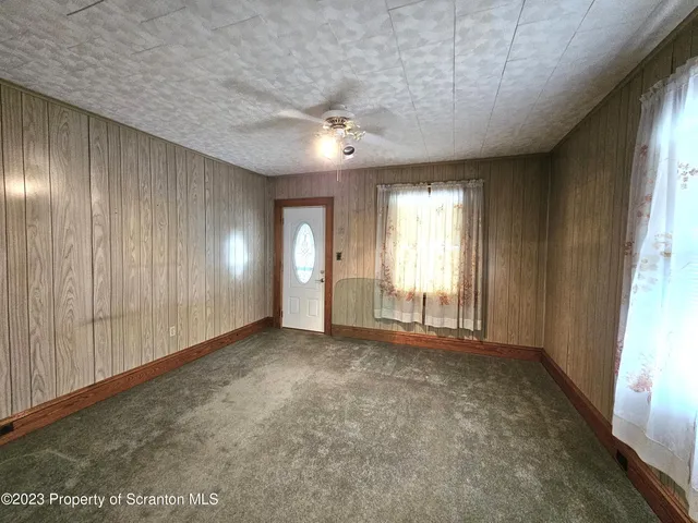 an empty room with windows and closet