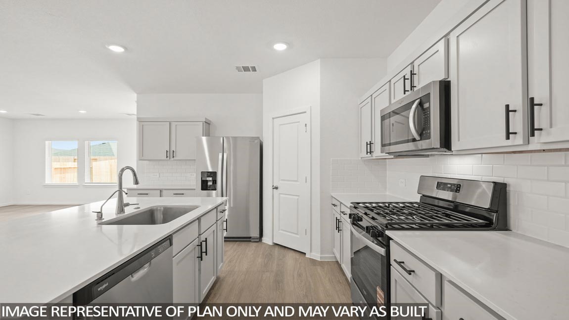 16763 Country Roots Avenue Conroe, TX 77302 - Photo 2 of 29 a kitchen with stainless steel appliances granite countertop a sink stove and refrigerator