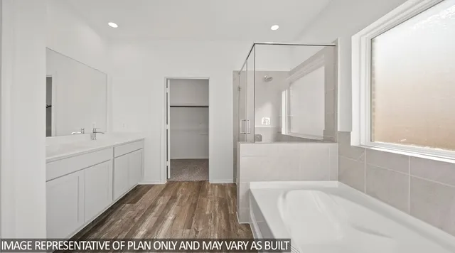 a bathroom with a tub sink and mirror