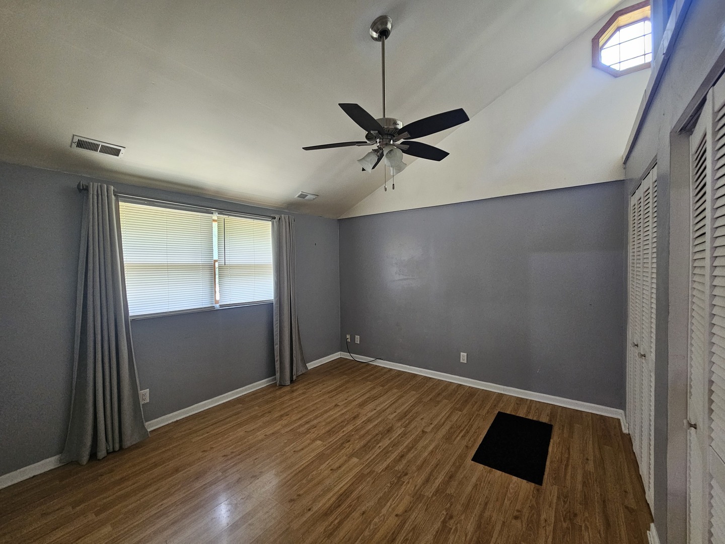 10N827 Hawthorne Street Elgin, IL 60123 - Photo 8 of 14 wooden floor in an empty room with a window