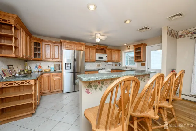 a large kitchen with stainless steel appliances granite countertop a stove and a sink