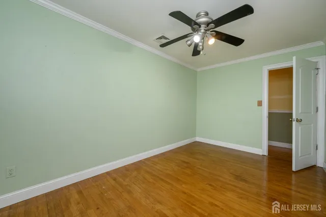 an empty room with a fan and a ceiling fan