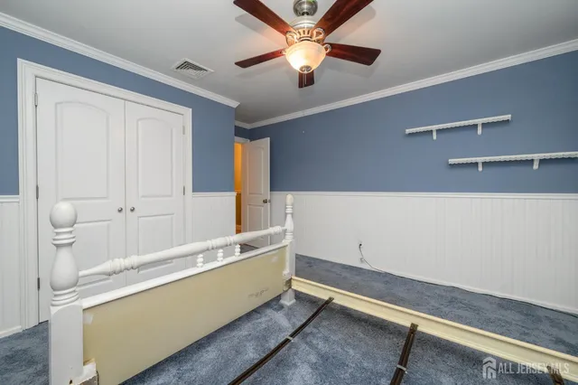 a living room with hard wood floors and a ceiling fan
