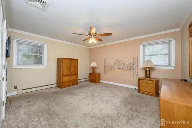 a view of a livingroom with wooden floor and a ceiling fan