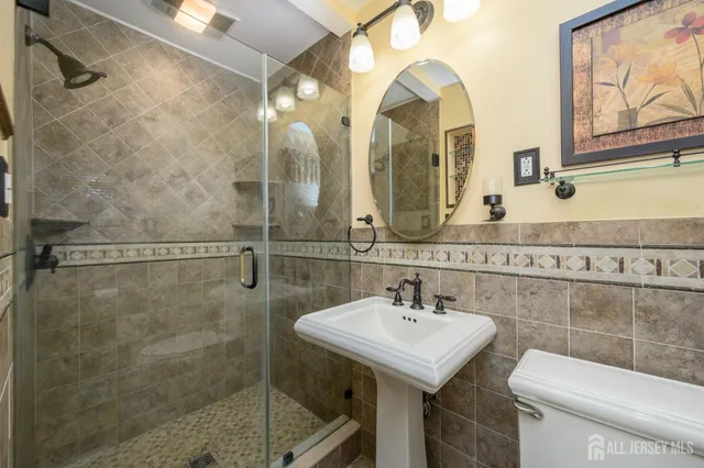 a bathroom with a sink mirror and toilet