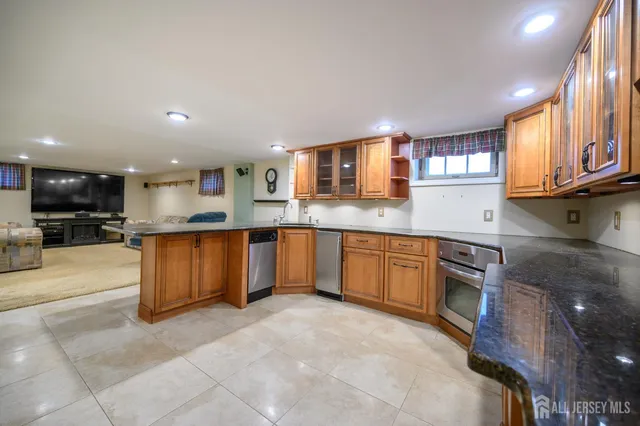 a kitchen with stainless steel appliances granite countertop a stove sink and cabinets