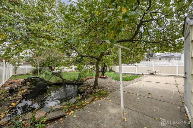a view of a chair and table in backyard