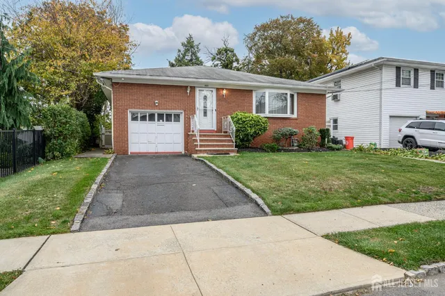 a front view of house with yard and green space
