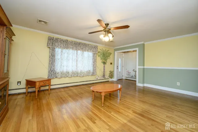 a living room with a furniture wooden floor and a window